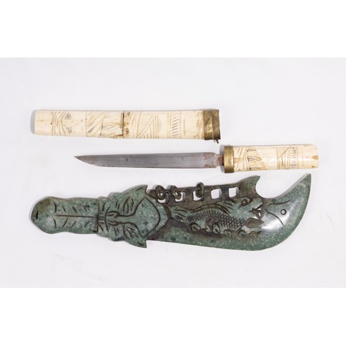 317 - **NO RESERVE**

A Chinese Jade and Bone Dagger with Carved Dragon Motifs.

A Chinese dagger with a j... 