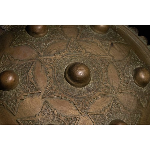 56 - **NO RESERVE**

An Indo-Persian Brass Shield with Star Motif and Seven Raised Bosses.

A circular In... 