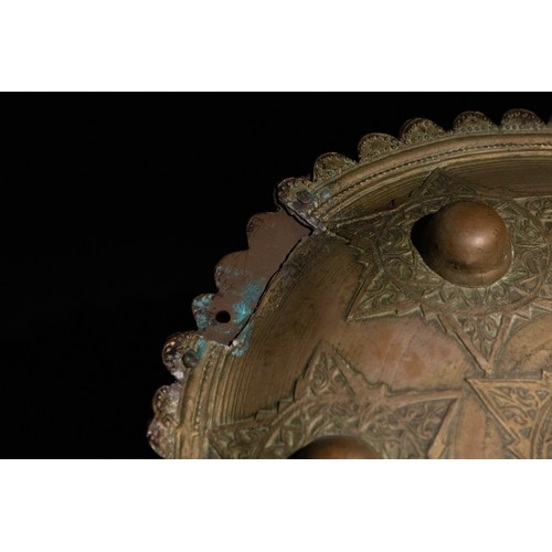 56 - **NO RESERVE**

An Indo-Persian Brass Shield with Star Motif and Seven Raised Bosses.

A circular In... 