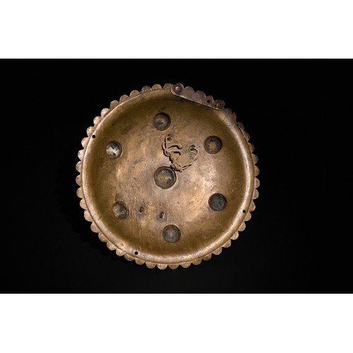 56 - **NO RESERVE**

An Indo-Persian Brass Shield with Star Motif and Seven Raised Bosses.

A circular In... 