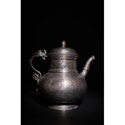 19 - An Islamic Timurid Copper Ewer with Engraved Calligraphy and Dragon Handle.

A copper ewer featuring... 