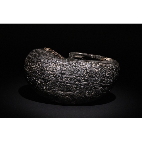 23 - An Islamic  Kashkul Beggar's Bowl with Calligraphic and Floral Engravings.

A dark-toned Kashkul fea... 