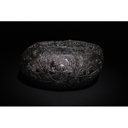 23 - An Islamic  Kashkul Beggar's Bowl with Calligraphic and Floral Engravings.

A dark-toned Kashkul fea... 