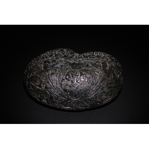 23 - An Islamic  Kashkul Beggar's Bowl with Calligraphic and Floral Engravings.

A dark-toned Kashkul fea... 