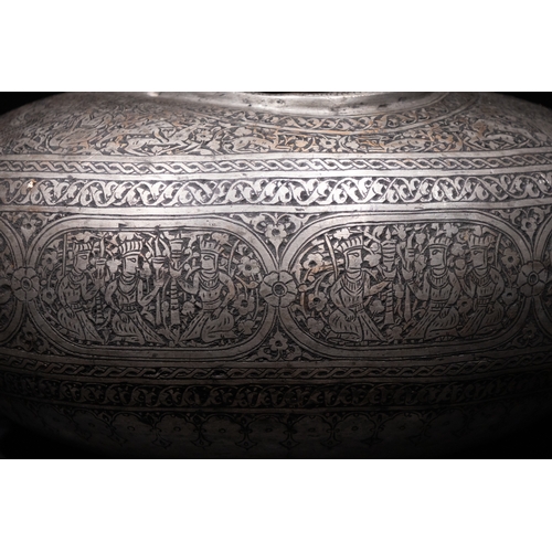 28 - An Islamic Iron Kashkul Beggar's Bowl with Courtly Figures & Floral Patterns.

A finely crafted iron... 