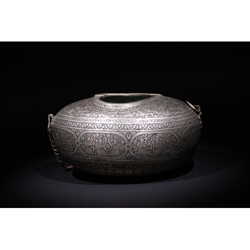 28 - An Islamic Iron Kashkul Beggar's Bowl with Courtly Figures & Floral Patterns.

A finely crafted iron... 