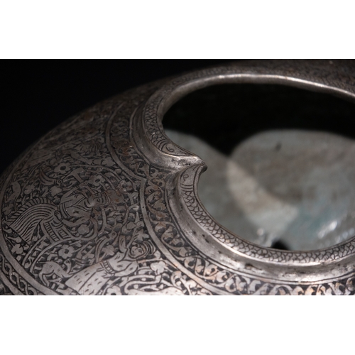 28 - An Islamic Iron Kashkul Beggar's Bowl with Courtly Figures & Floral Patterns.

A finely crafted iron... 