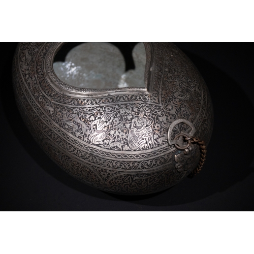 28 - An Islamic Iron Kashkul Beggar's Bowl with Courtly Figures & Floral Patterns.

A finely crafted iron... 