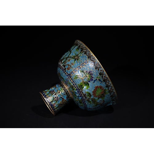 324 - **NO RESERVE**

A Chinese Plique-à-Jour Enamel Stem Cup on a Carved Hardwood Stand.

A translucent C... 