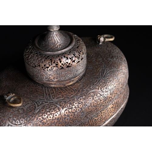39 - A Rare Safavid Tinned Copper Lidded Kashkul Beggar's Bowl with Arabic Inscriptions, 17th Century.

A... 