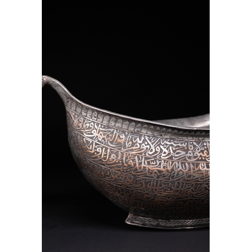 41 - A Tinned Copper Islamic Kashkul Beggar's Bowlwith Dragon-Head Handles, Deccan, 17th Century.

The ka... 