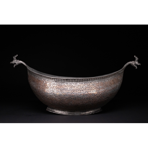 41 - A Tinned Copper Islamic Kashkul Beggar's Bowlwith Dragon-Head Handles, Deccan, 17th Century.

The ka... 