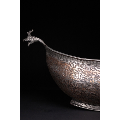 41 - A Tinned Copper Islamic Kashkul Beggar's Bowlwith Dragon-Head Handles, Deccan, 17th Century.

The ka... 