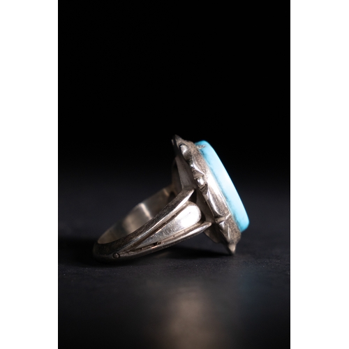 58 - An Islamic Silver Ring with Inscribed Turquoise Stone.

A silver ring showcasing a bright sky-blue t... 