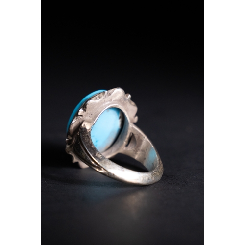 58 - An Islamic Silver Ring with Inscribed Turquoise Stone.

A silver ring showcasing a bright sky-blue t... 