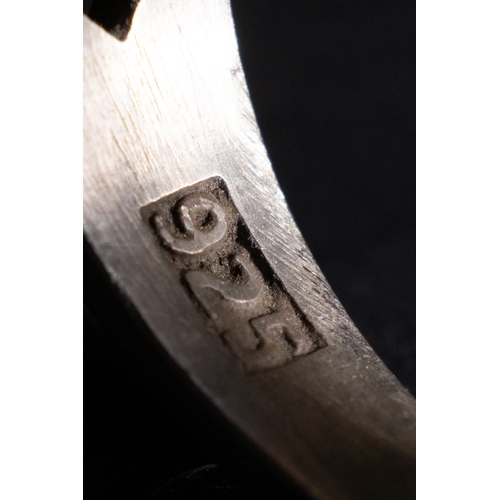 61 - An Islamic Silver Ring with Inscribed Lavender Agate.

A silver ring featuring an oval lavender agat... 