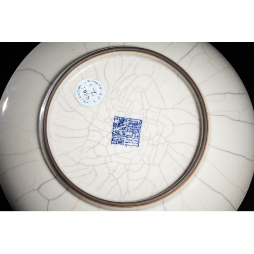 364 - A Chinese Ge-Type Crackle-Glazed Porcelain Dish with Qianlong Mark. 
A finely potted Chinese porcela... 