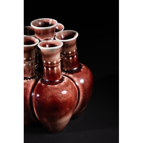 270 - A Chinese Sang de Boeuf Glazed Porcelain Five-Neck Vase - A multi-necked porcelain vase featuring a ... 