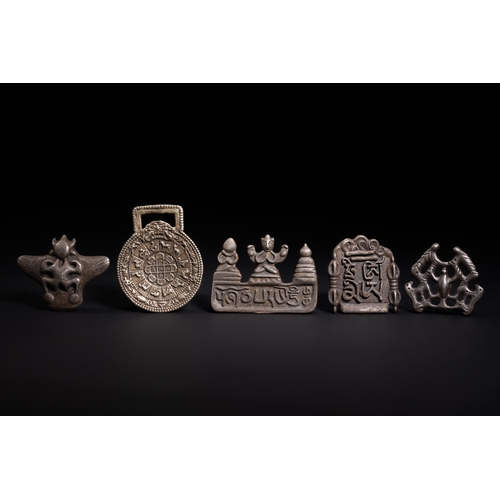 258 - A Collection of Tibetan White Metal Amulets and Plaques.

A group of Tibetan white metal amulets and... 