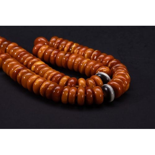 184 - An Islamic Butterscotch Amber Bead Strand.

A strand composed of rounded, flattened butterscotch amb... 