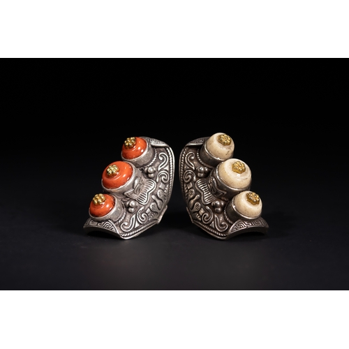261 - A Pair of Tibetan White Metal Rings Set with Cabochons.

A matched pair of Tibetan white metal rings... 