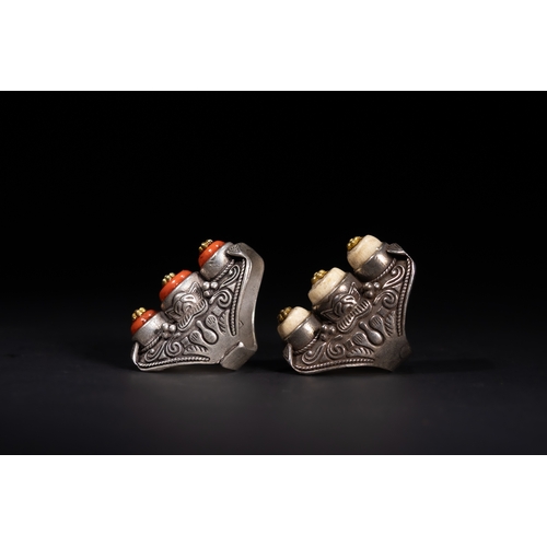 261 - A Pair of Tibetan White Metal Rings Set with Cabochons.

A matched pair of Tibetan white metal rings... 