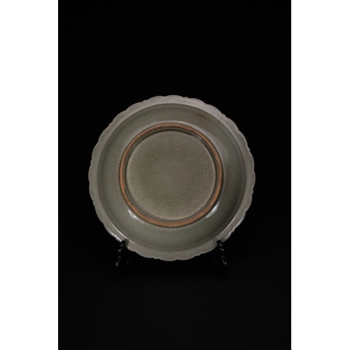 448 - A Chinese Celadon-Glazed Carved ‘Dragon and Peony’ Dish.

A celadon-glazed dish with a scalloped rim... 