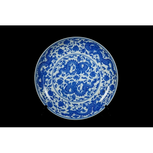 318 - A Chinese Blue and White 'Dragon' Dish, Kangxi Mark. - A circular Chinese blue and white porcelain d... 