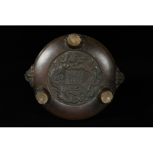 331 - A Chinese Bronze Tripod Censer, Xuande Mark. - A Chinese bronze tripod censer, featuring a circular,... 