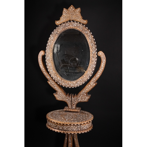 74 - An Indian Wood and Bone Inlaid Dressing Mirror on Stand, 20th Century.

A 20th century Indian carved... 