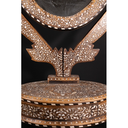 74 - An Indian Wood and Bone Inlaid Dressing Mirror on Stand, 20th Century.

A 20th century Indian carved... 