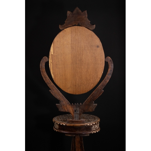 74 - An Indian Wood and Bone Inlaid Dressing Mirror on Stand, 20th Century.

A 20th century Indian carved... 
