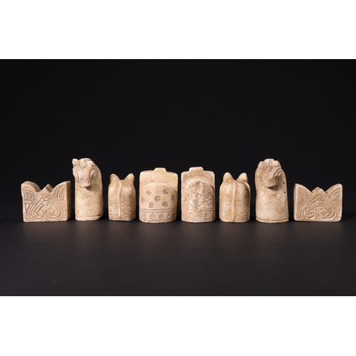 31 - A Complete Stone Half Chess Set, 19th Century.

A complete carved stone half chess set comprising si... 