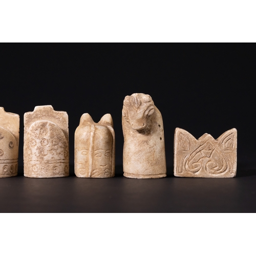 31 - A Complete Stone Half Chess Set, 19th Century.

A complete carved stone half chess set comprising si... 