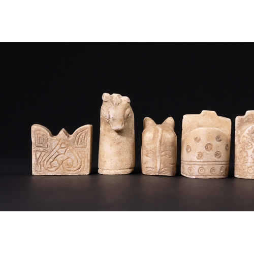 31 - A Complete Stone Half Chess Set, 19th Century.

A complete carved stone half chess set comprising si... 