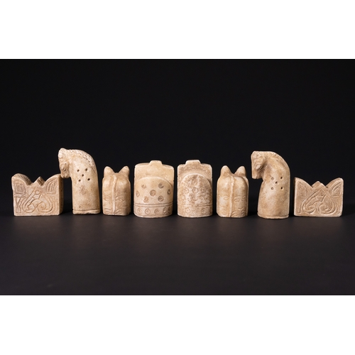 31 - A Complete Stone Half Chess Set, 19th Century.

A complete carved stone half chess set comprising si... 