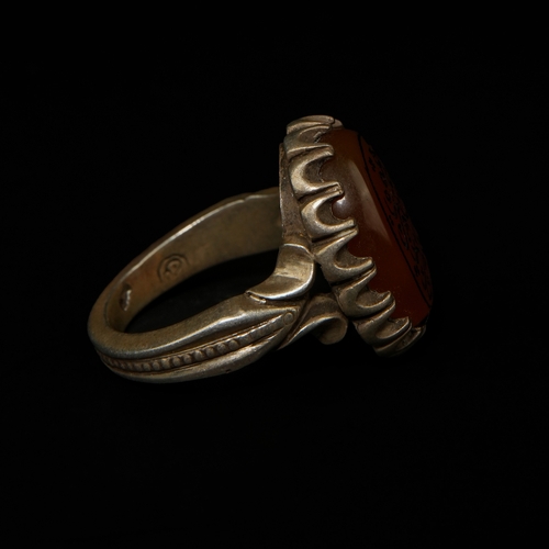 205 - An Islamic Silver Ring Set with an Oval Carved Agate Seal Stone.

An Islamic silver-mounted seal rin... 