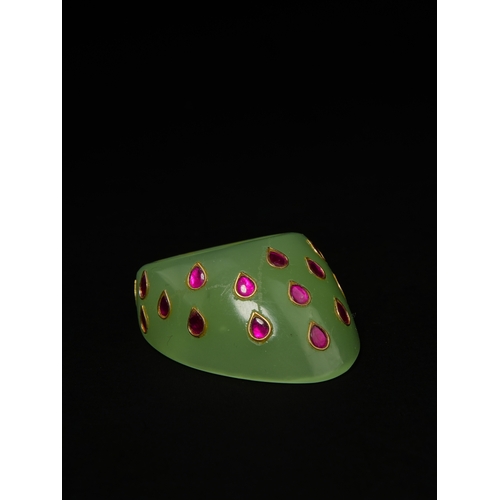 88 - A Mughal Green Glass Archer’s Thumb Ring with Gilded Inlaid Motifs.

An archer’s thumb ring carved f... 