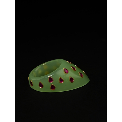 88 - A Mughal Green Glass Archer’s Thumb Ring with Gilded Inlaid Motifs.

An archer’s thumb ring carved f... 