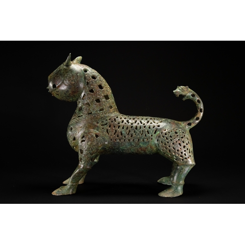 10 - A Khorassan Style Openwork Bronze Zoomorphic Figure.

The figure is cast in bronze, modelled as a st... 