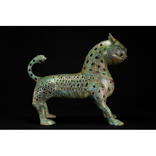 10 - A Khorassan Style Openwork Bronze Zoomorphic Figure.

The figure is cast in bronze, modelled as a st... 