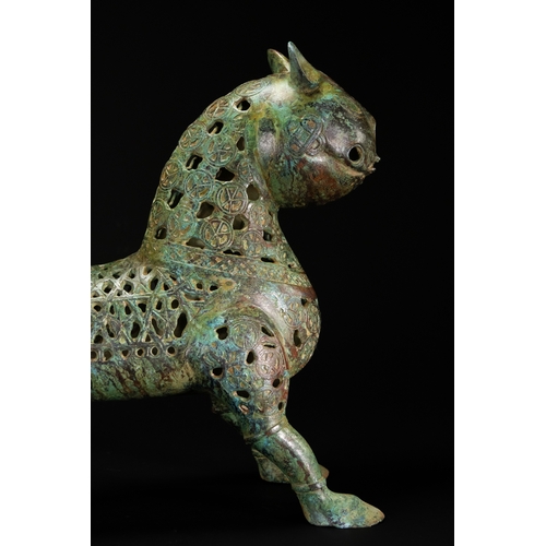 10 - A Khorassan Style Openwork Bronze Zoomorphic Figure.

The figure is cast in bronze, modelled as a st... 