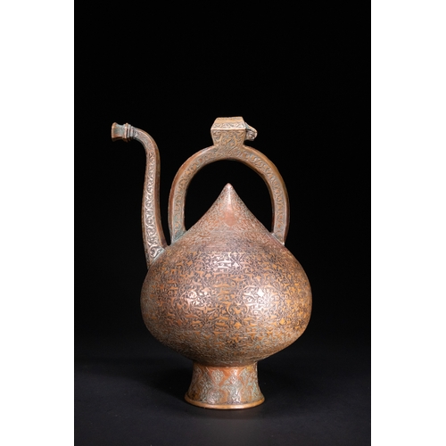 12 - An Islamic Copper Ewer with Incised Scrollwork, 19th Century.

An Islamic copper ewer featuring a bu... 