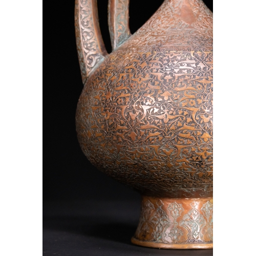 12 - An Islamic Copper Ewer with Incised Scrollwork, 19th Century.

An Islamic copper ewer featuring a bu... 