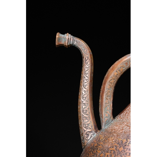 12 - An Islamic Copper Ewer with Incised Scrollwork, 19th Century.

An Islamic copper ewer featuring a bu... 