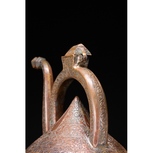 12 - An Islamic Copper Ewer with Incised Scrollwork, 19th Century.

An Islamic copper ewer featuring a bu... 