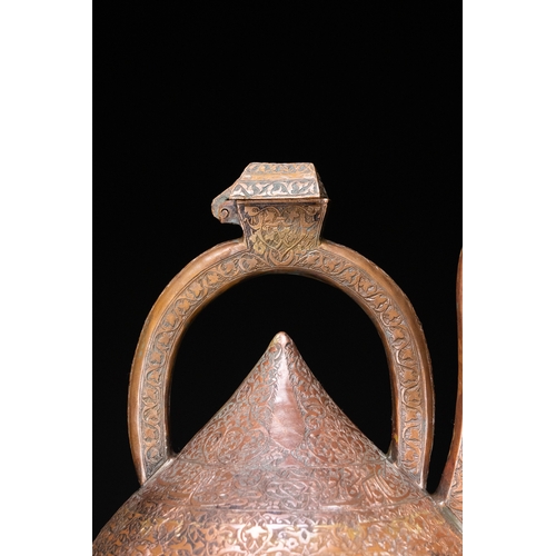 12 - An Islamic Copper Ewer with Incised Scrollwork, 19th Century.

An Islamic copper ewer featuring a bu... 
