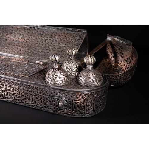 13 - A Safavid Openwork Copper Qalamdan Pen Box with Qur’anic Inscriptions, 17th Century.

An elongated S... 