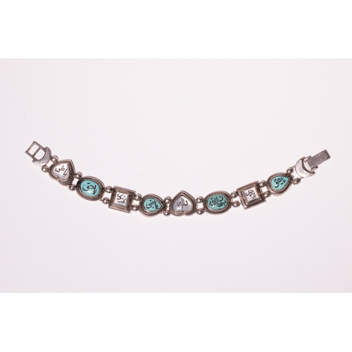 21 - A Middle Eastern Silver and Turquoise Inset Bracelet with Arabic Inscriptions.

A decorative silver ... 
