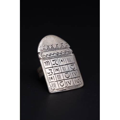 26 - A Tuareg Tribal Berber Silver Talismanic Ring.

The ring is crafted in silver, featuring a large, re... 